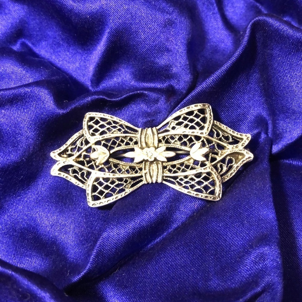 Antique sterling silver stamped  intricate bow tie brooch. Delicate and dainty